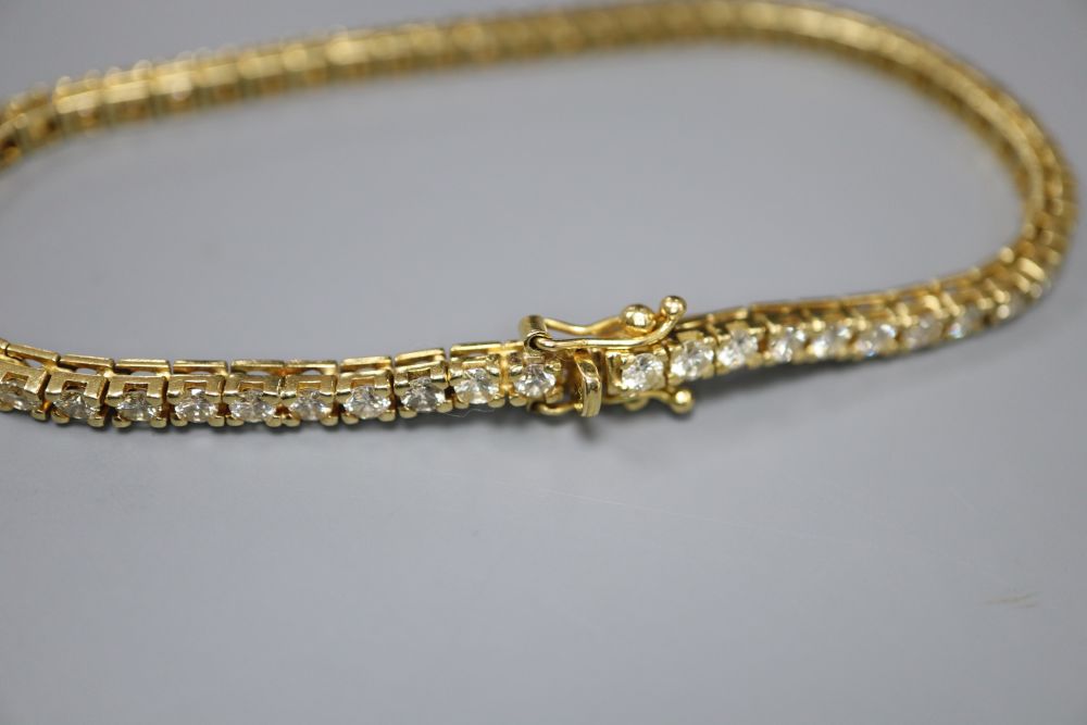 A modern Italian 18ct gold and diamond set line bracelet, 18.8cm, gross 13.7 grams,